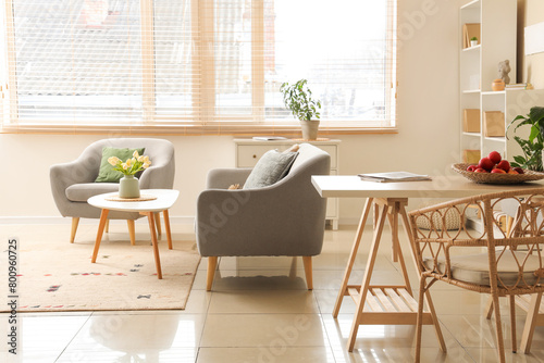 Interior of stylish living room with sofa, coffee table, carpet and window © Pixel-Shot