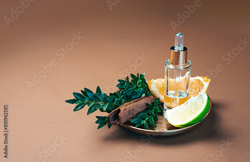 Aromatherapy and perfumery background, adorned with cinnamon sticks, lime, orange and the finest essential oil.