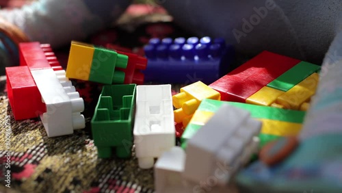 Children's cubes of different colors. The child builds a constructor, plays in the yard. Toys for preschoolers, child development. Children's entertainment