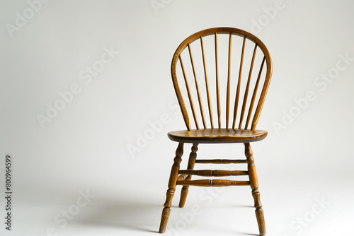 A simple and elegant Windsor chair with a white background, isolated on solid white background.