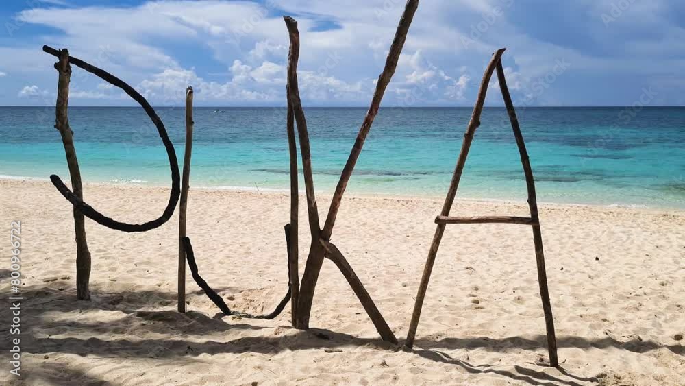 Puka Shell Beach Sign Made From Tree Branches on White Sand, Boracay Island, Philippines, Close Up Puka Shell Beach Sign Made From Tree Branches on White Sand, Boracay Island, Philippines, Close Up