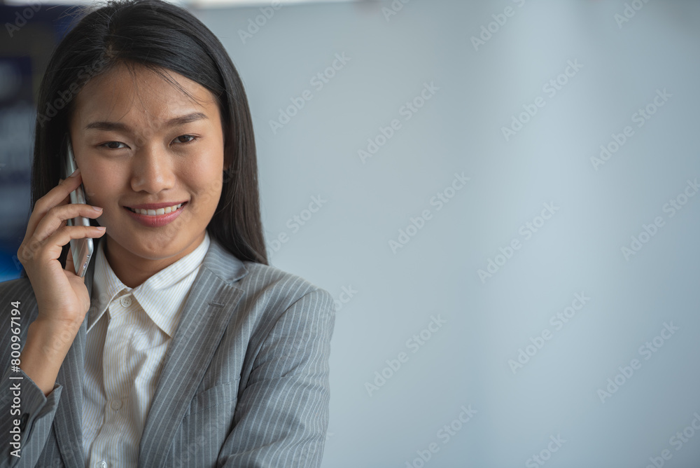 A young businesswoman is talking on the phone and smiling. A young businesswoman is talking on the phone and smiling.