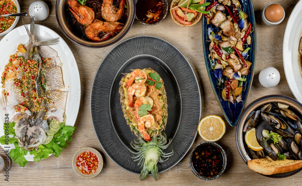 A table full of delicious food, including seafood, meat, and vegetables. A table full of delicious food, including seafood, meat, and vegetables.
