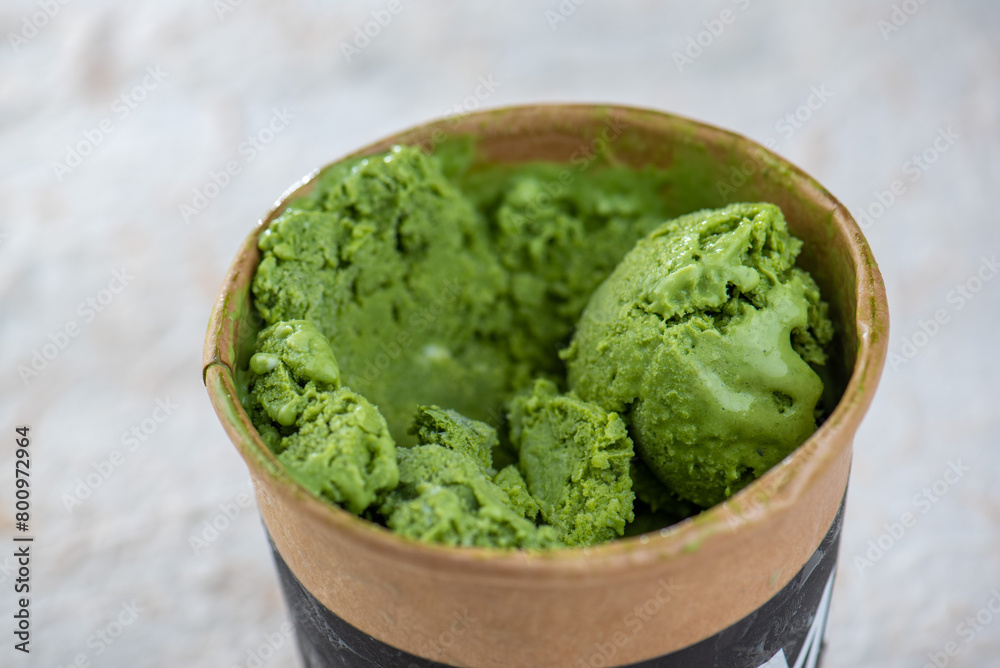 Matcha green tea ice cream in a brown cup Matcha green tea ice cream in a brown cup