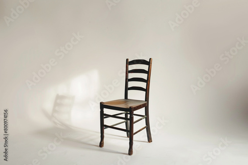 A traditional ladderback chair on a clean white backdrop.