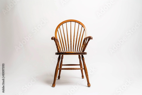 A traditional Windsor chair showcased on a solid white backdrop, isolated on solid white background.