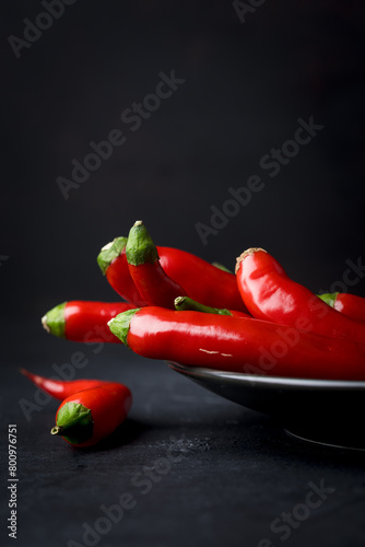 Red and hot Chili pepper on black background