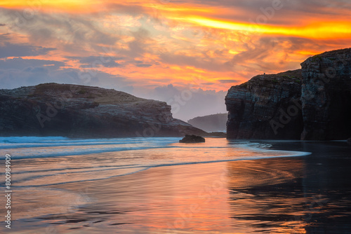 Cathedrals beach (Playa de las Catedrales) or Praia de Augas Santas at sunrise, amazing landscape with rocks on the Atlantic coast and colored sky, Ribadeo, Galicia, Spain. Outdoor travel background photo