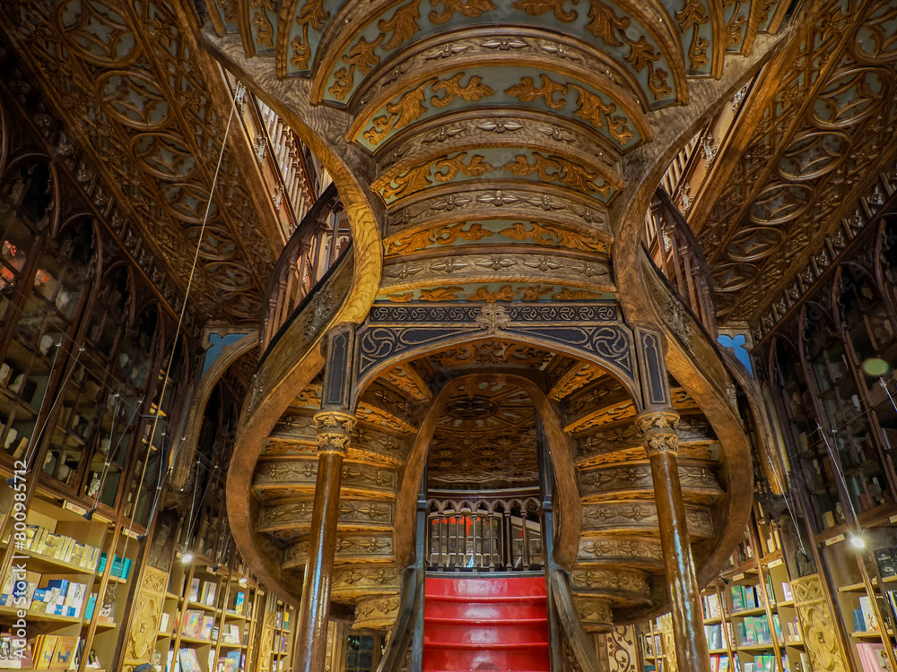 Fototapeta premium PORTO, PORTUGAL - APRIL 21 2024 Interior view of Lello bookstore in Portuguese with its wooden staircase famous for Harry Potter film