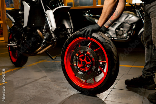 In a motorcycle repair shop motorcycle suspension system is replacing a wheel