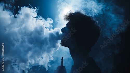 A young man is exhaling a cloud of smoke from his mouth photo
