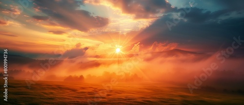 Majestic Sunrise Over Misty Mountain Landscape with Dramatic Sky. © Qstock