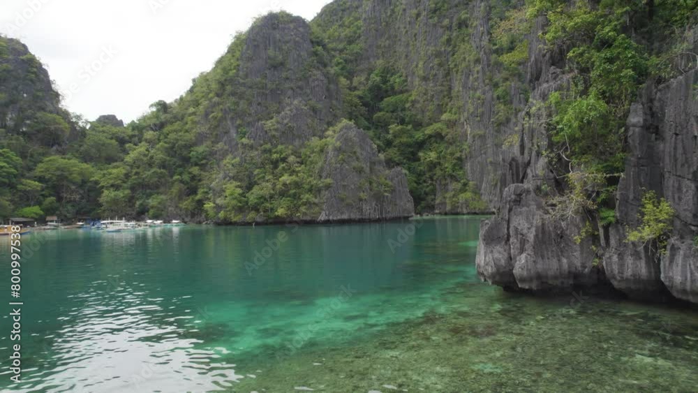 Aerial view of the amazing Big Lagoon in El Nido, Palawan, Philippines. Shallow lagoon with blue water amid jagged Karst Rock cliffs and lush tropical jungle Aerial view of the amazing Big Lagoon in El Nido, Palawan, Philippines. Shallow lagoon with blue water amid jagged Karst Rock cliffs and lush tropical jungle