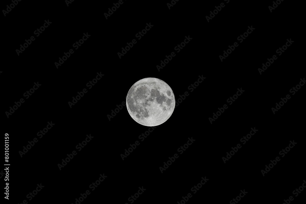 the moon is rising high above the horizon in a dark sky the moon is rising high above the horizon in a dark sky