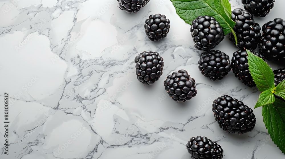 Blackberries lie on the white marble surface Blackberries lie on the white marble surface