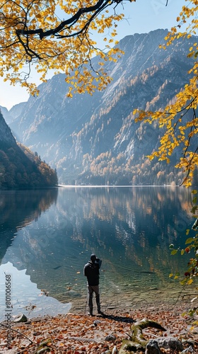 Man photographing KÃ¶nigsee lake in Alps in fall photo