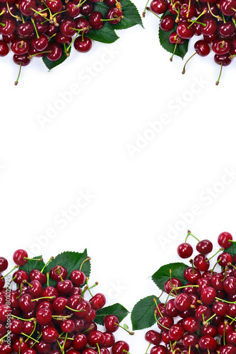Red juicy cherries with green leaves on a white background with space for text. Top view, flat lay © Anastasiia Malinich