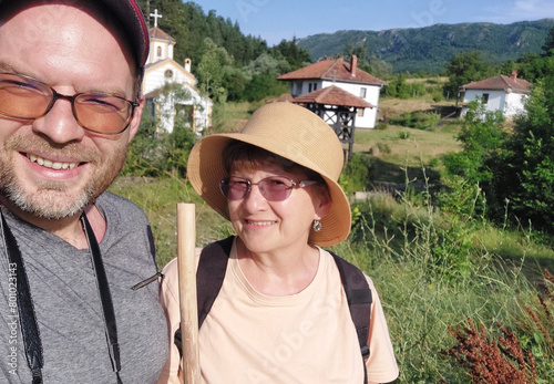 Mother and son taking photos of themselves in nature as they hike