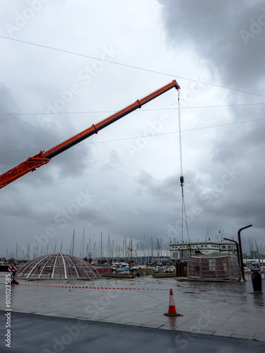 Assembling Holiday Cheer: Crane at Work by the Harbor