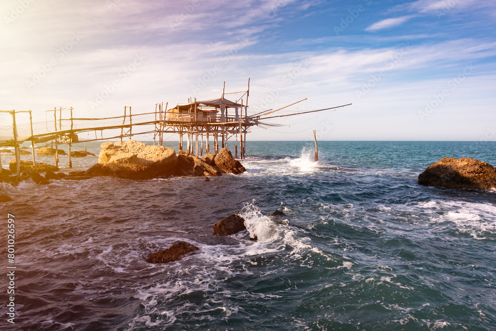 Traditional wooden fishing house with a net near sea coast