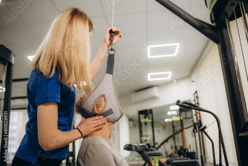 Senior woman workout in rehabilitation center. Personal trainer helping senior woman