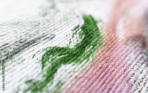 Green, white and pink brush strokes on an artistic canvas close -up