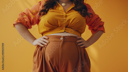 plus-size woman in stylish autumn outfit. Close-up of midsection, hands on hips showcasing fashion and body positivity. Empowerment and style concept. Design for fashion campaign, poster, and banner