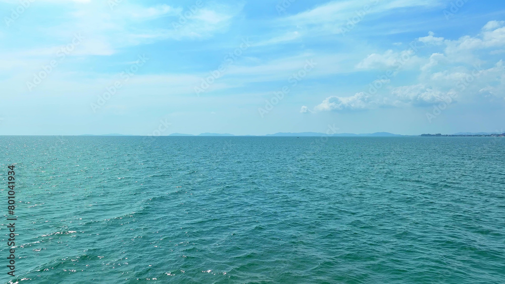 Obraz premium Drone's eye view reveals the deep blue sea merging seamlessly with the vast expanse of a cloudless, cerulean sky. A picture of coastal serenity. Wonderstruck by nature: Spectacular surprises await. 