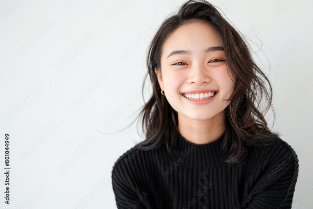 Beautiful studio portrait of young, stylish asian woman, long hair, smiling and looking at camera with confidence on white background Beautiful studio portrait of young, stylish asian woman, long hair, smiling and looking at camera with confidence on white background