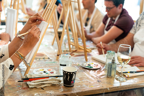 Painting workshop. Students drawing on a blank canvas.