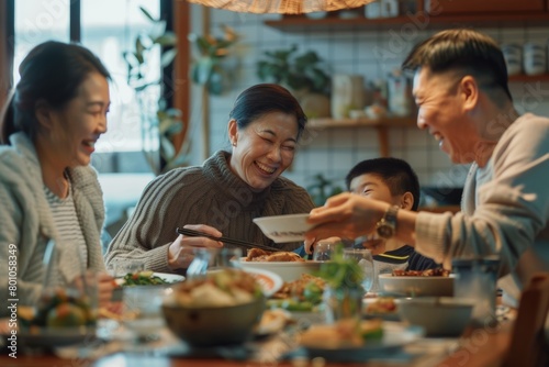 Happy family breakfast hour  father  mother  son  and daughter sit at a table filled with food in a dining room.