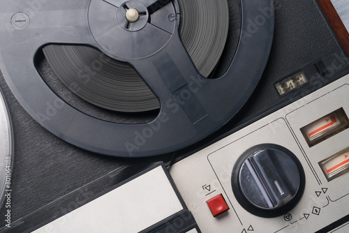 close-up of a black and white music player recorded on magnetic tape of round reels