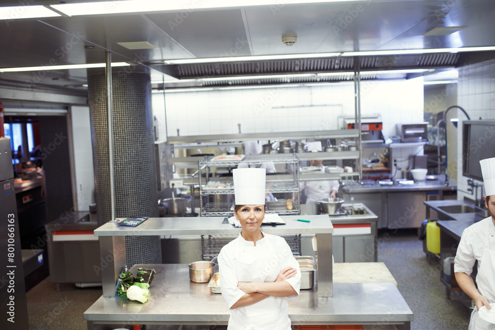 Chef, woman and confident in industrial kitchen, restaurant and gourmet meal prep and serving. Crossed arms, catering service and culinary skills, nutrition and working in hospitality industry