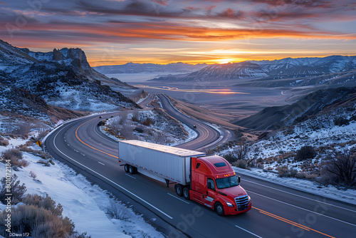 Semi Truck Driving Down Curving Road at Sunset