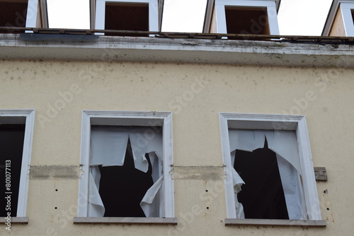 old building with broken windows photo