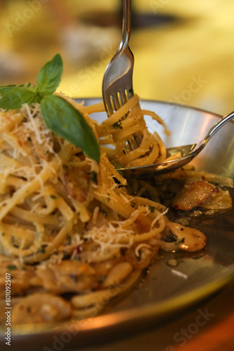 Rolling pasta with a spoon or fork