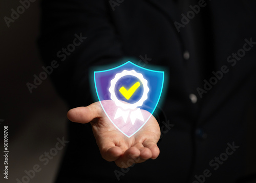 Man hand hold icon for security protection systems and satisfaction on virtual screen. Certified guarantee approval or secure access system concept. Feedback and survey success questionnaire rating.