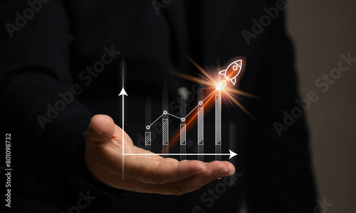 Man hand with stock market graph with rocket. Finance chart investment growth high. The currency trading economy strategy situation. Market and exchange analyzing data.