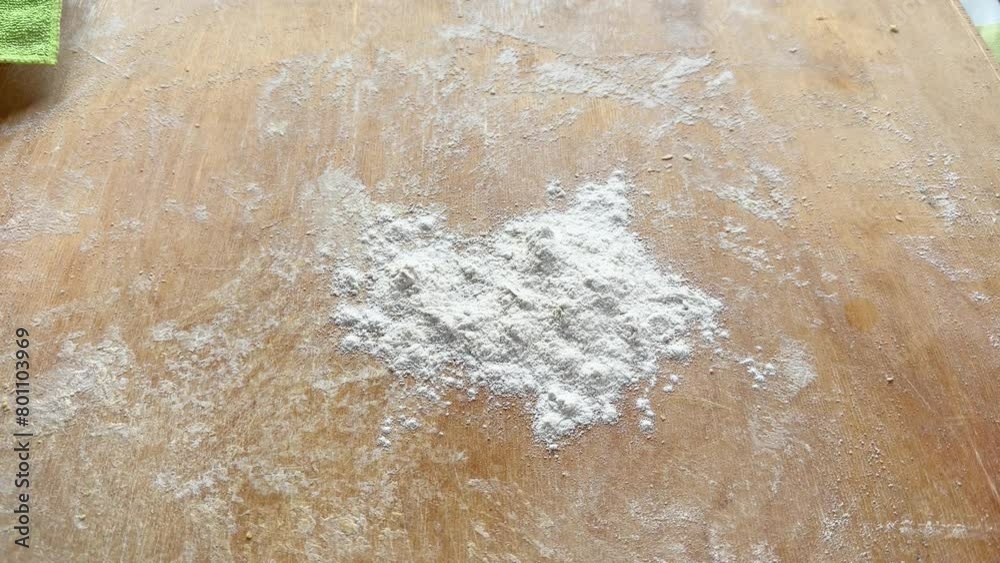 Covering cutting board, rolling pin with flour for dough rolling Covering cutting board, rolling pin with flour for dough rolling