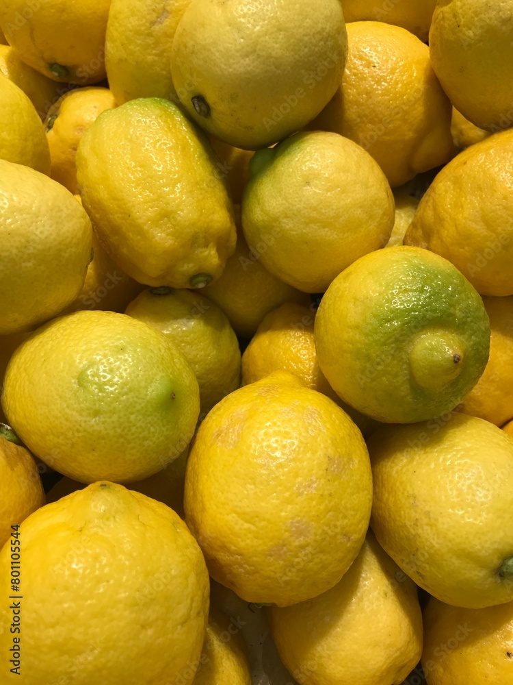 Ripe yellow lemons close up background or texture. Lemon harvest, many yellow lemons.