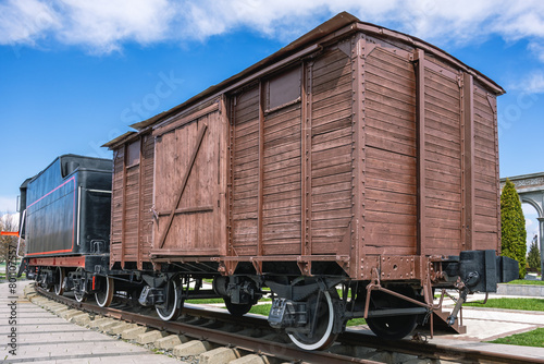 An old wooden two-axle boxcar. A type of railway two-axle covered freight car. The design of the wagon provides for the possibility of rapid conversion for the transportation of people and animals.