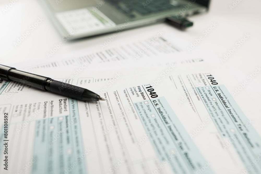 Tax time concept.Tax form with office supplies on white. financial document.Tax Form 1040.