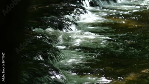 Small waterfalls in the sunshine on the Tanew River
