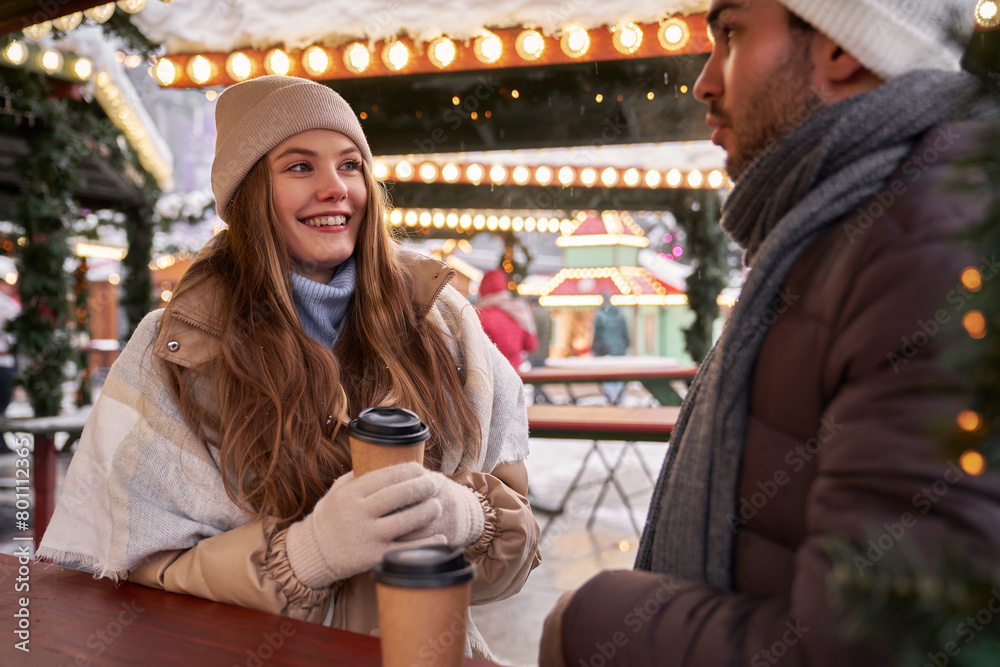 Caucasian couple having fun on Christmas market Caucasian couple having fun on Christmas market