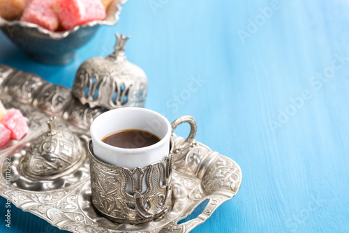 Traditional Turkish coffee and Turkish delight on blue wooden background © Antonel