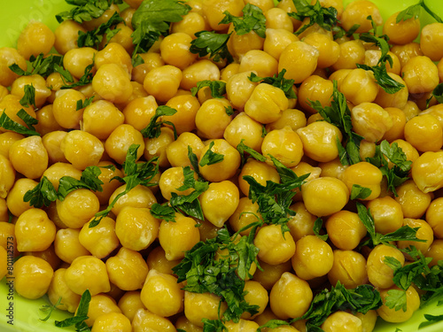 Fresh boiled chick-peas sprinkling with fresh parsley, background