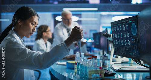 Fotografie Biotechnology Research Laboratory: Female Asian Doctor Working With Test Tubes To Study Effect Of Innovative Alzheimer's Medicine