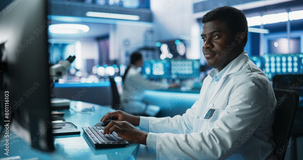 Black Male Doctor Using Desktop Computer In Modern Hospital Medical Research Laboratory. African American Practitioner Checking Test Results Of Patients, Drugs Prescription, Symptoms History. Black Male Doctor Using Desktop Computer In Modern Hospital Medical Research Laboratory. African American Practitioner Checking Test Results Of Patients, Drugs Prescription, Symptoms History.