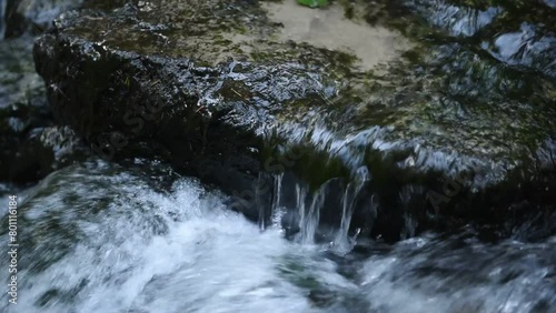 Water flowing over a stone in a river