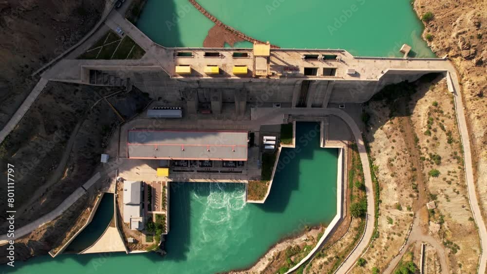 Dam and water reservoir. Panoramic aerial view of the gravity dam and hydroelectric plant. Aerial orbit view. Hydroelectric power station. Renewable energies. Toktogul hydroelectric power station on Dam and water reservoir. Panoramic aerial view of the gravity dam and hydroelectric plant. Aerial orbit view. Hydroelectric power station. Renewable energies. Toktogul hydroelectric power station on